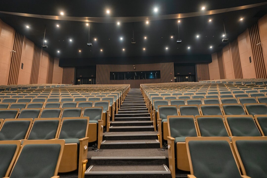 Empty modern conference hall set up with chairs and stage for a corporate event